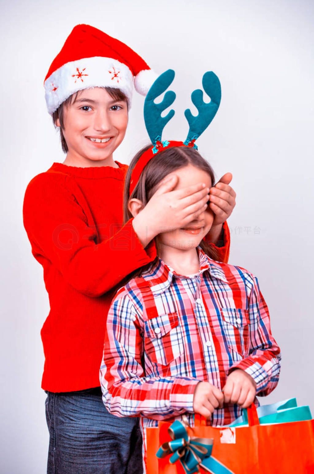 Young brother and sister at home for Christmas. Happy family in