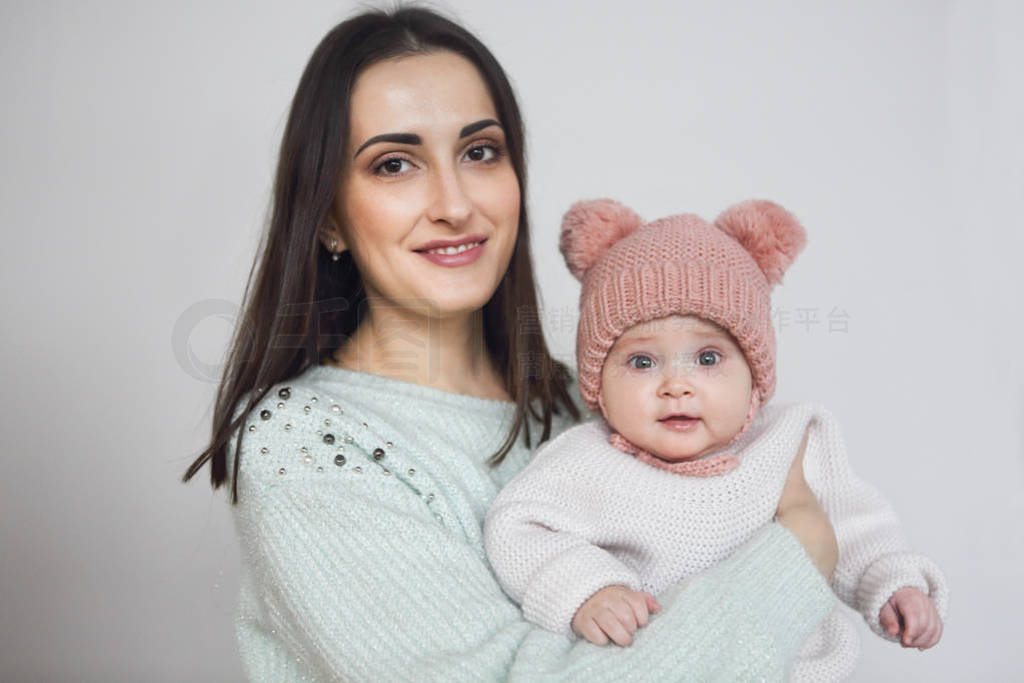 Mother and baby playing and smiling, happy family indoors