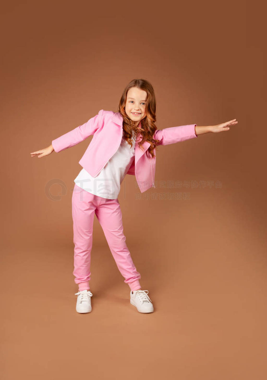 girl in a pink tracksuit makes bends