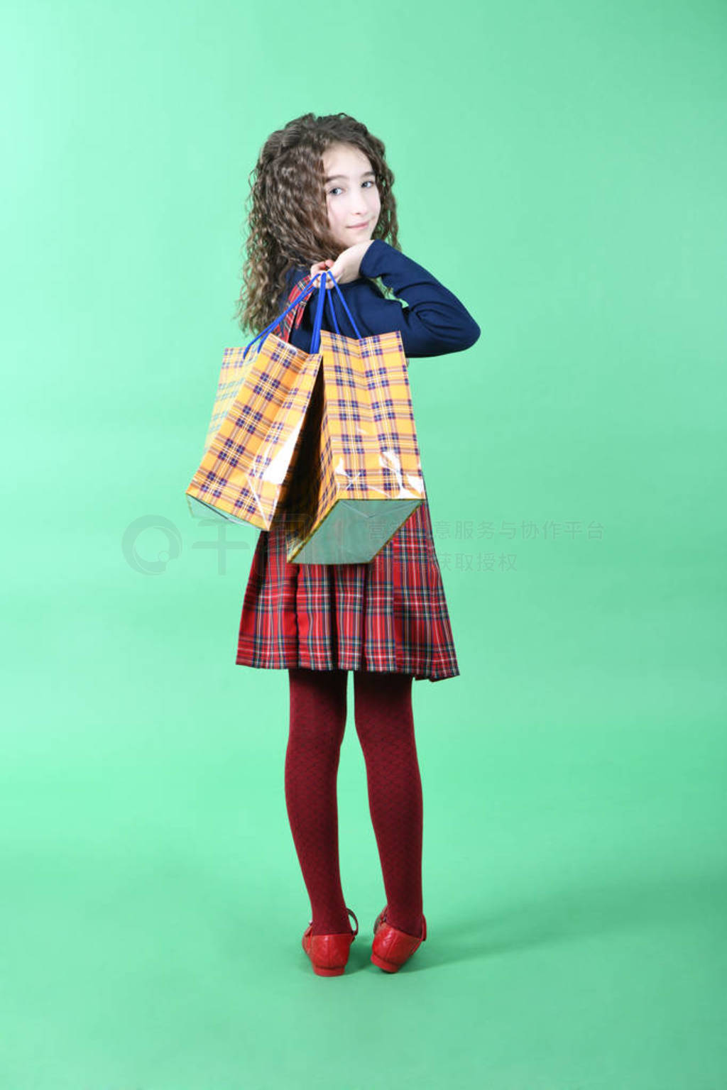 Child with a yellow packaging checkered texture isolated on gre