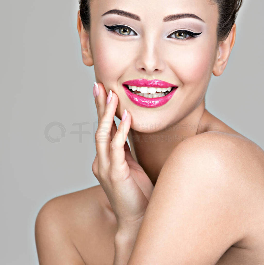 Smiling face of young woman with creative hairstyle