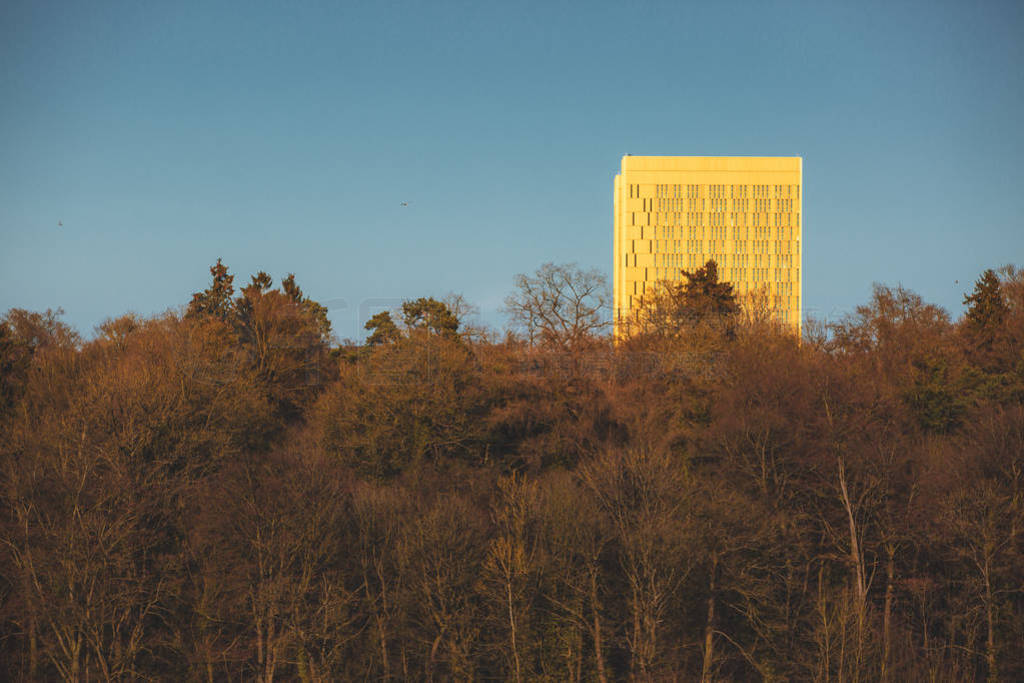 Golden Skyscraper building above the forest in Luxembourg