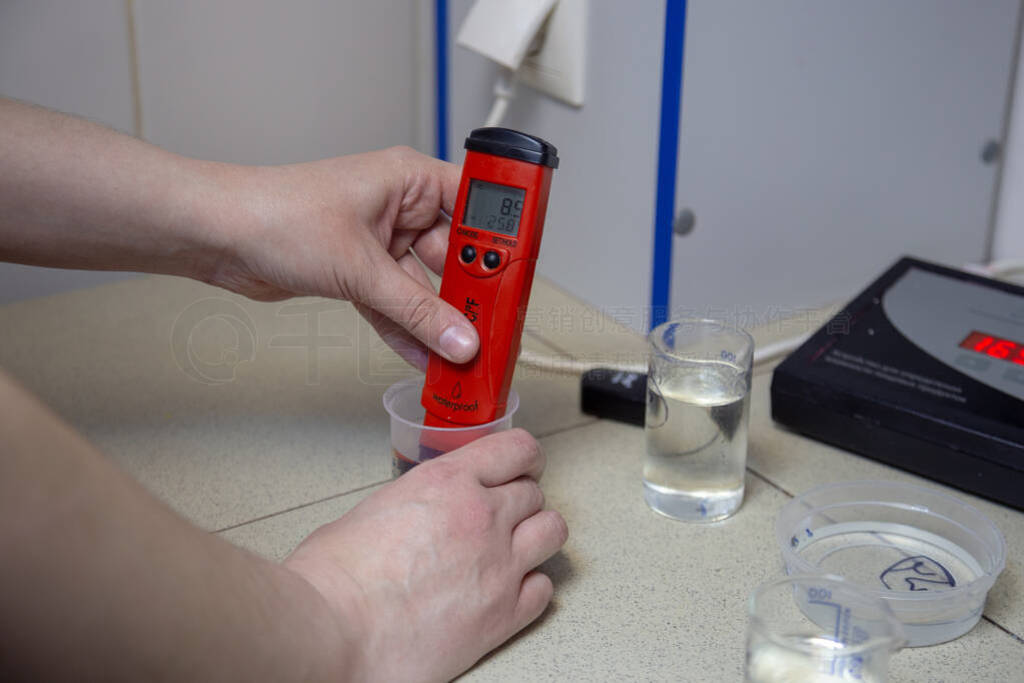 Laboratory assistant measuring pH in chemical laboratory using