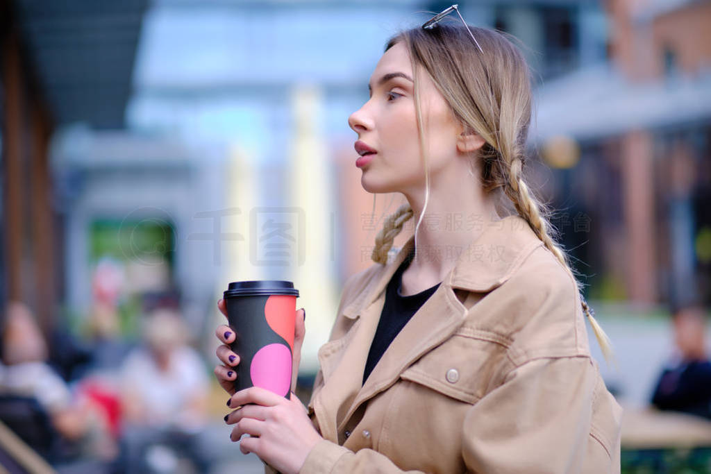 beautiful woman drinking coffee in big city outdoors