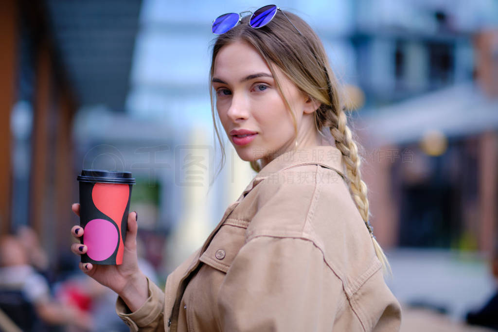 beautiful woman drinking coffee in big city outdoors