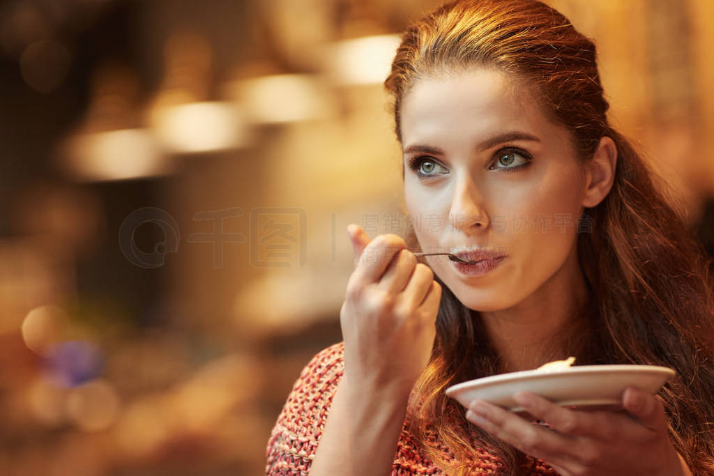 young beautiful woman eating a dessert