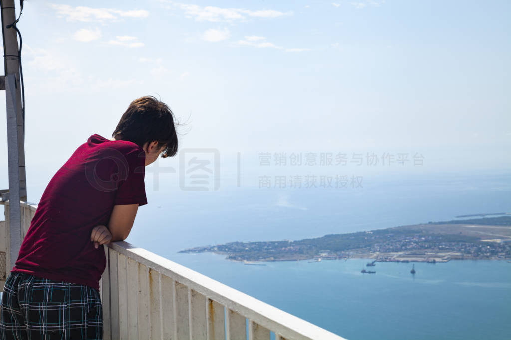 Young man stands on the observation deck