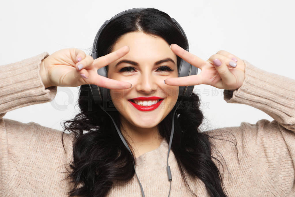 woman looking at camera with smile and showing peace sign with