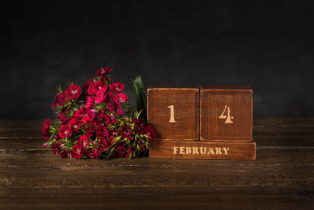 s Day vintage wooden Perpetual calendar for February 14 on a bla