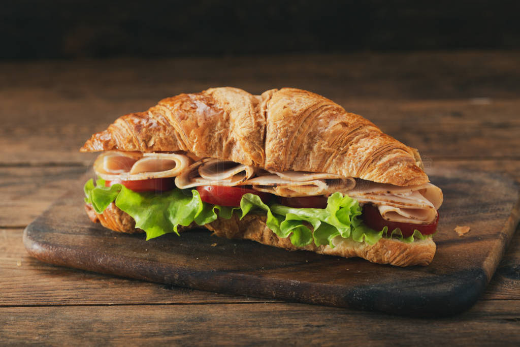 croissant sandwich with ham and vegetables