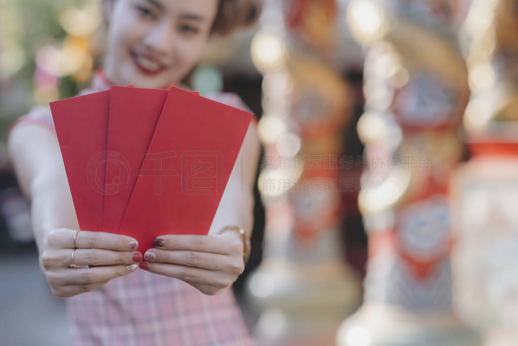 Lunar New Year celebrations with red envelopes in hands.