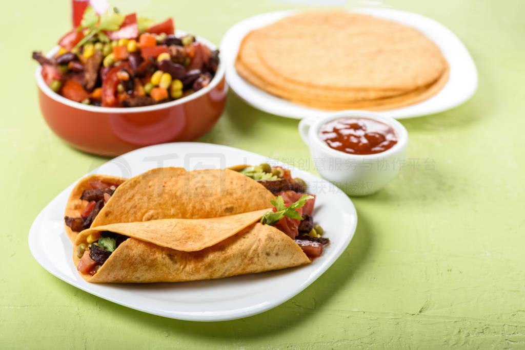 Tacos - delicious tortillas with meat and vegetables