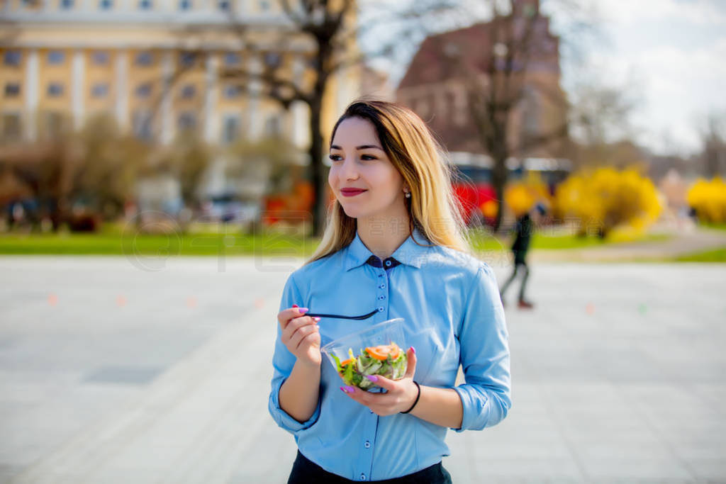 Young business woman with salad lunch box on outdoor