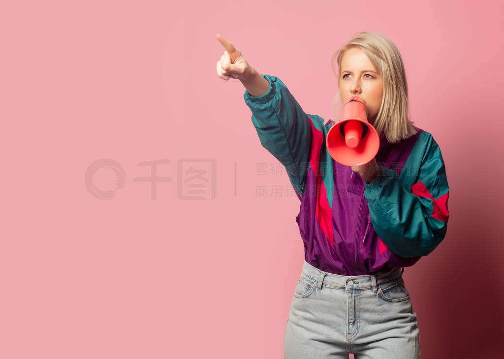 Beautiful blonde woman in 90s clothes with loudspeaker