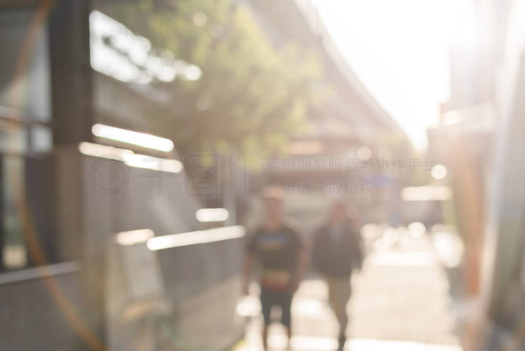 city scenery with people walking against sunbeam