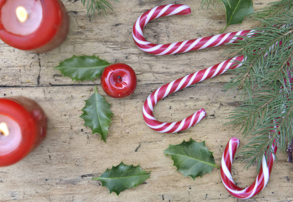 top view on candy canes and christmas decoration with canddles o