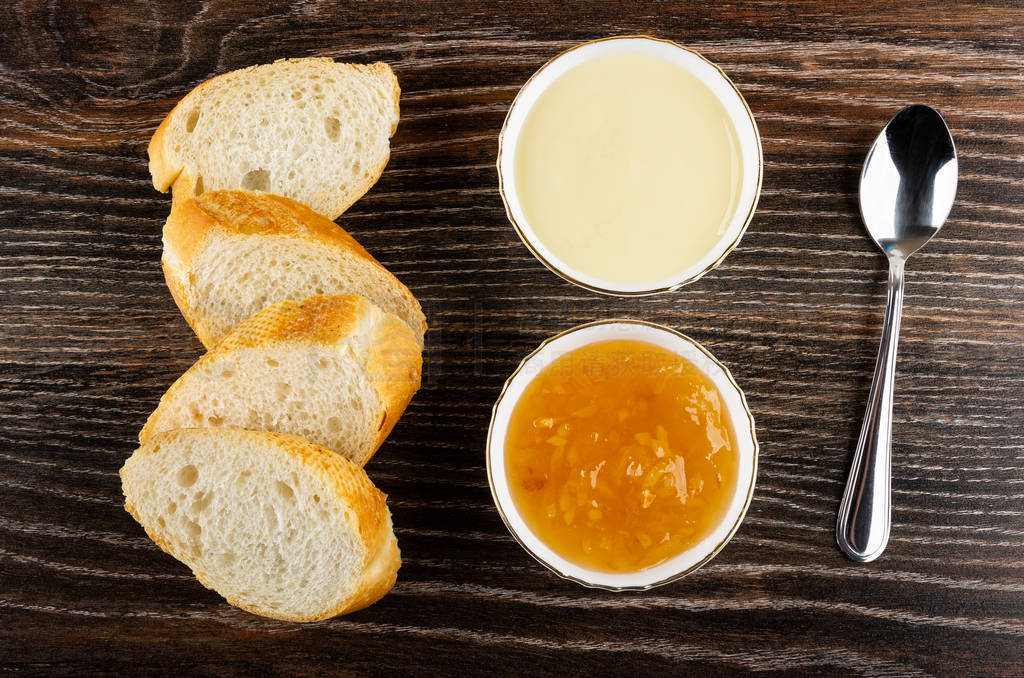 Slices of bread, bowls with condensed milk, lemon jam, spoon on