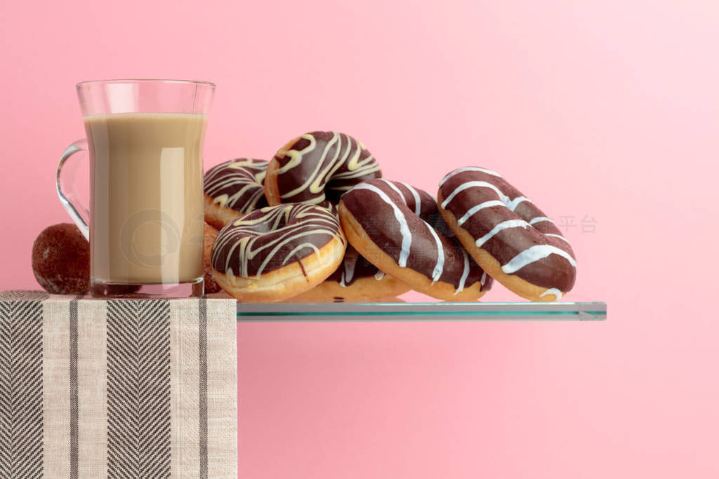 Chocolate donuts and latte on a black background.