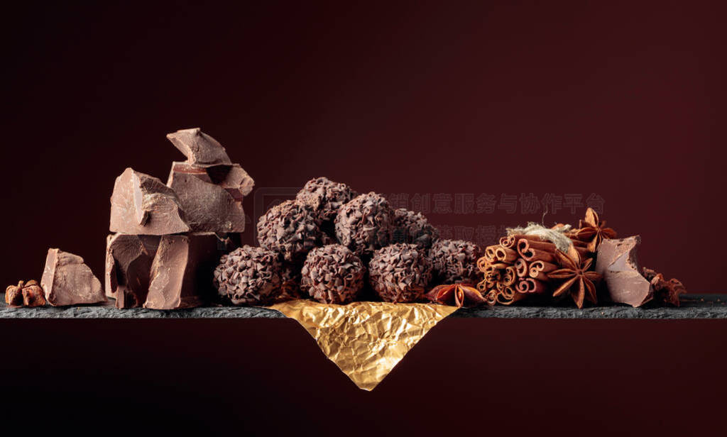 Chocolate truffles with broken pieces of chocolate and spices.