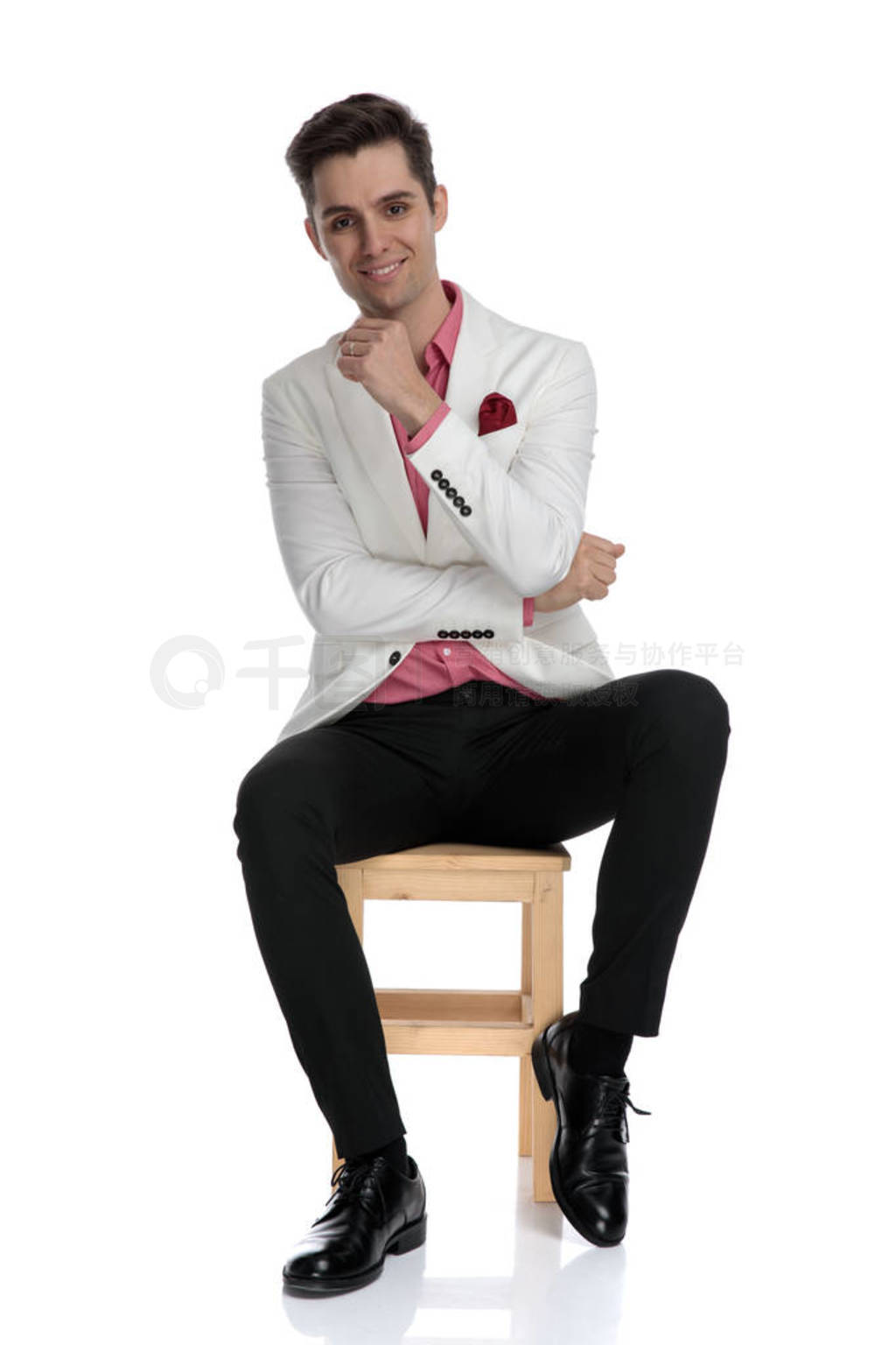 seated smiling young elegant man waiting for a job interview