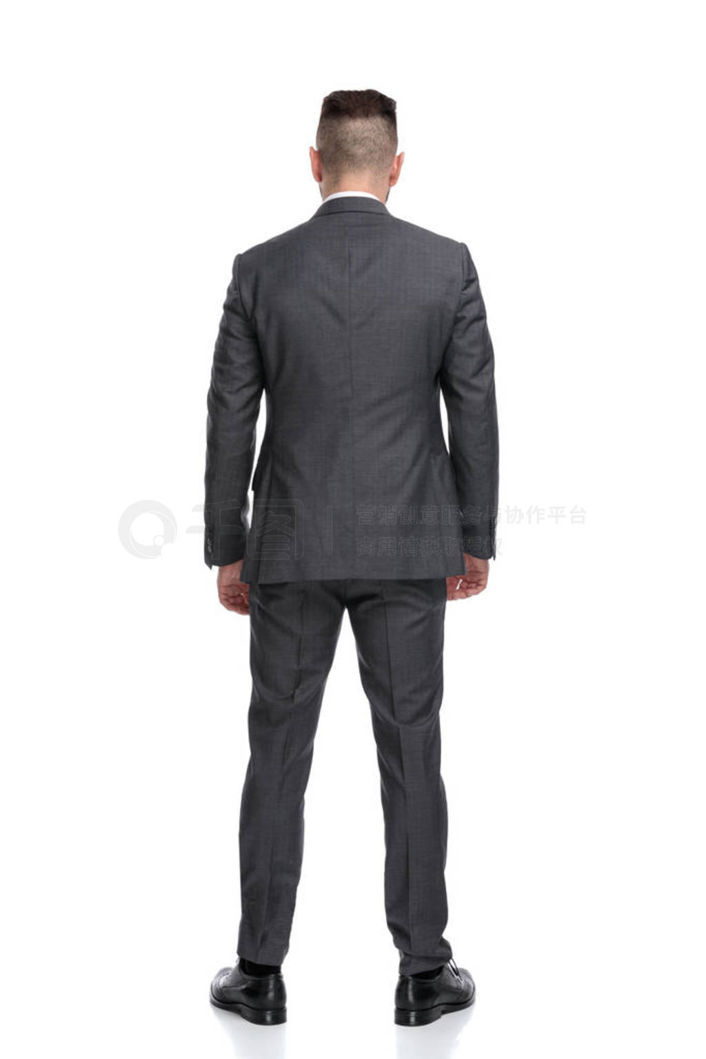 back view of a young businessman standing