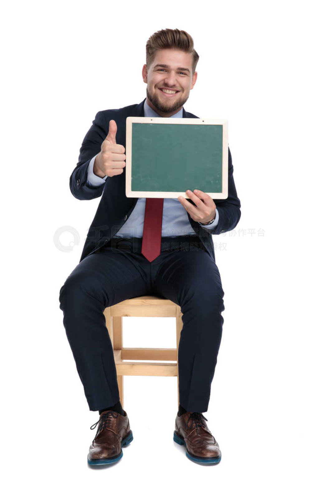 happy young businessman holding blackboard