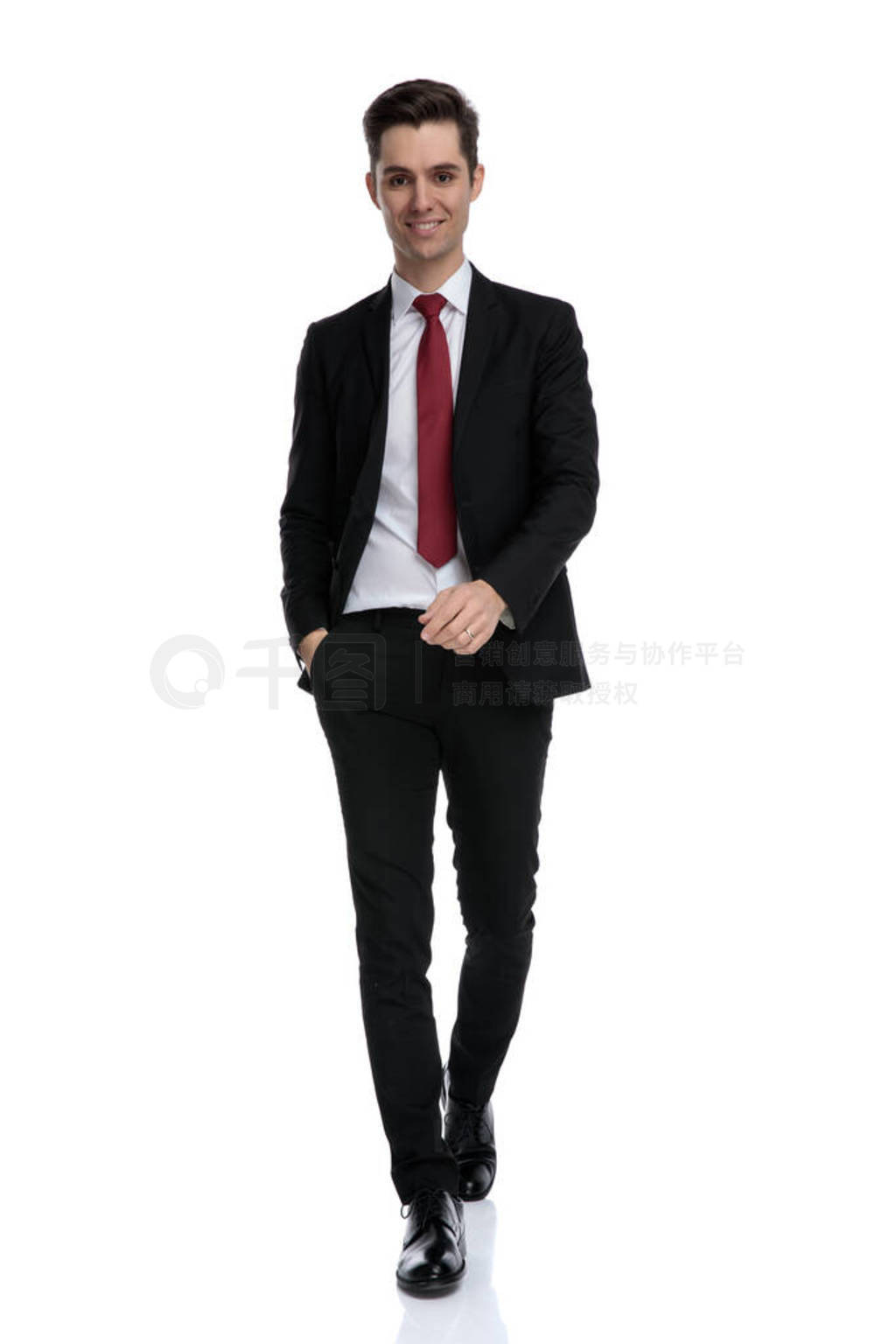 Merry businessman holding his hand in his pocket