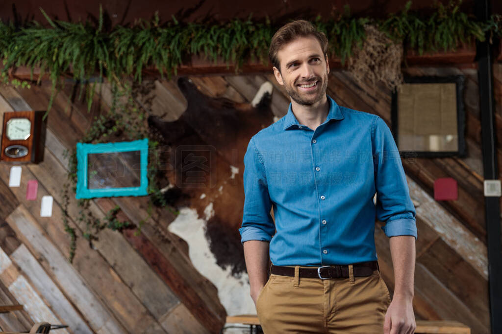 Hopeful businessman looking away with his hand in his pocket