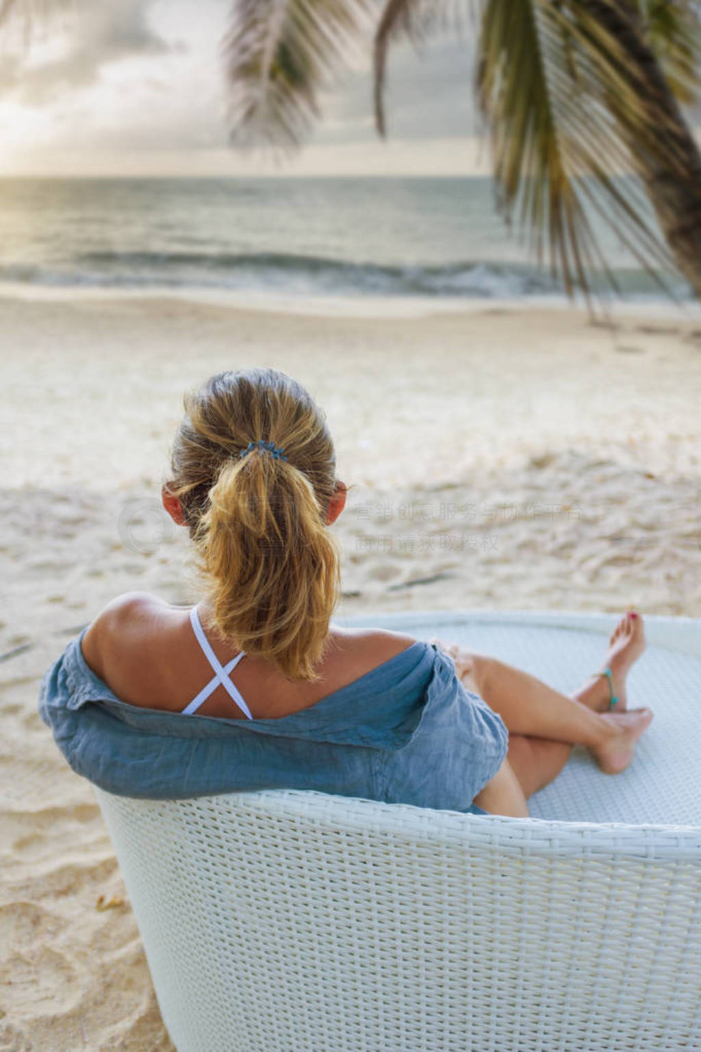 Woman enjoying her holidays on a transat at the tropical beach