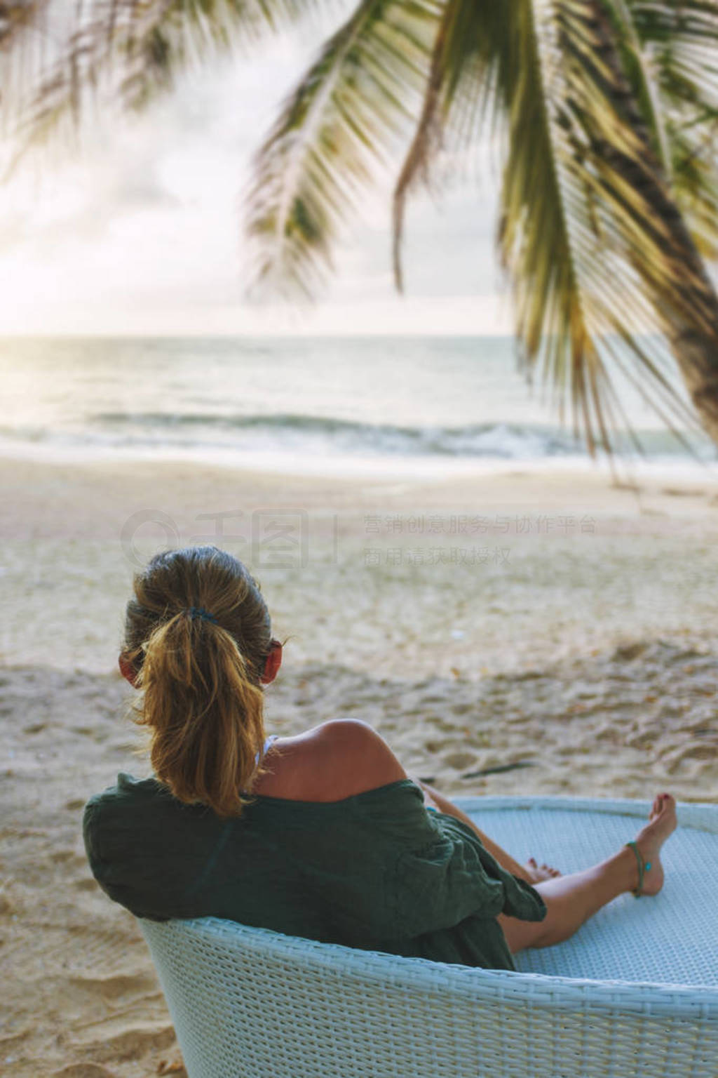 Woman enjoying her holidays on a transat at the tropical beach