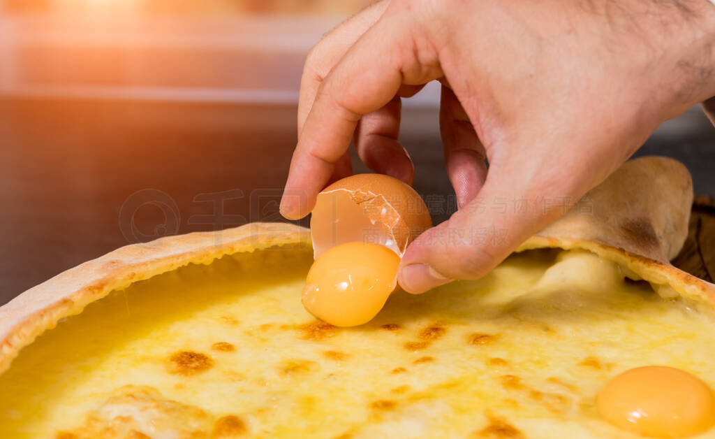 Chef cooking khachapuri with cheese and egg. Georgian national c