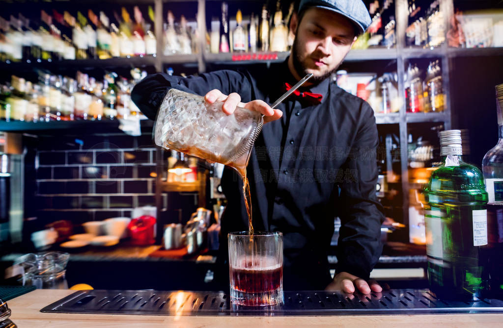 Bartender is making cocktail at bar counter. Fresh cocktails.