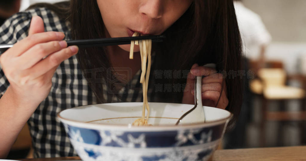 Woman eat noodles in restaurant