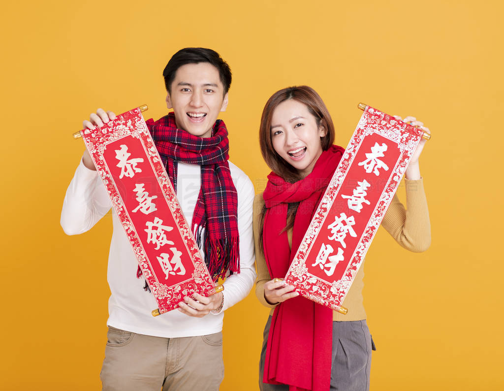 happy asian young couple celebrating chinese new year. chinese