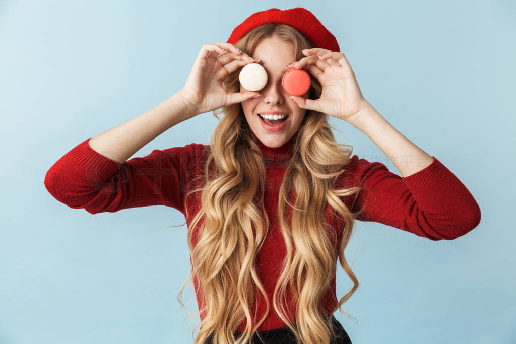 Image of cute blond woman 20s wearing red beret holding macaron