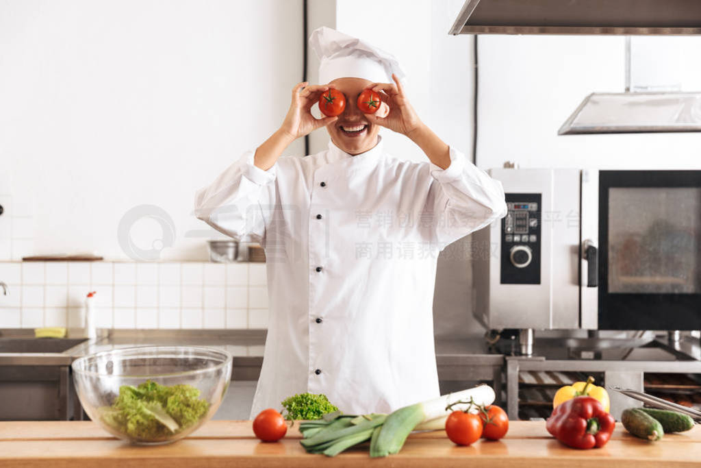 Photo of cheerful woman chef wearing white uniform cooking meal
