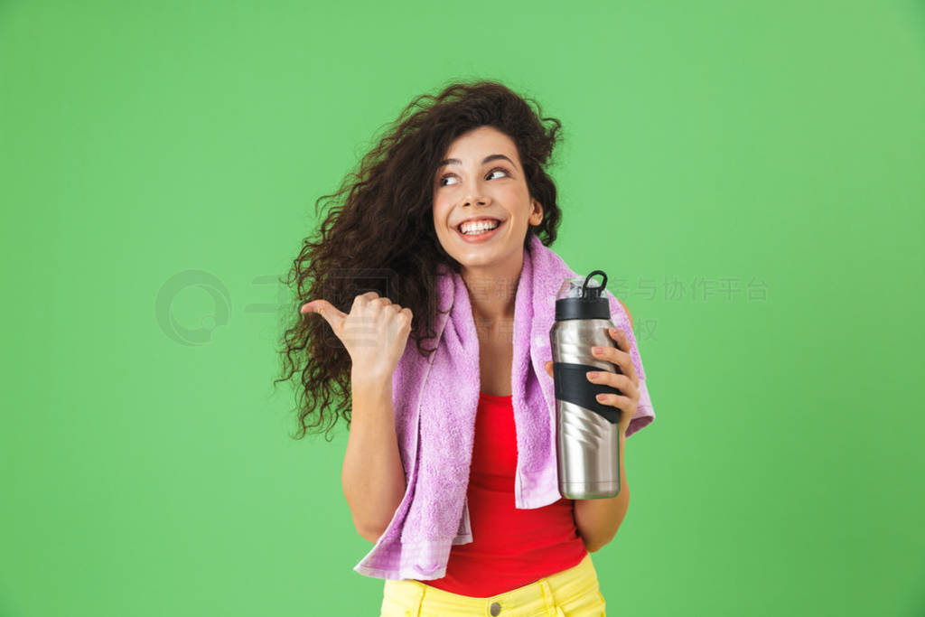 Image of healthy woman 20s in sportswear rejoicing and drinking