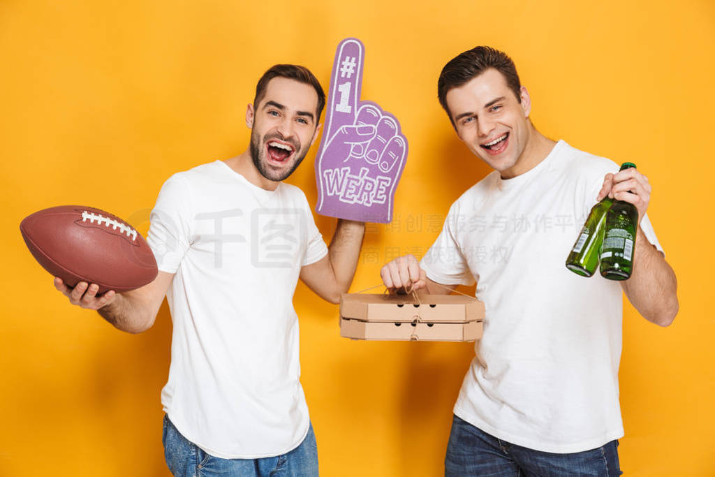 Image of two optimistic men 30s in white t-shirts holding rugby