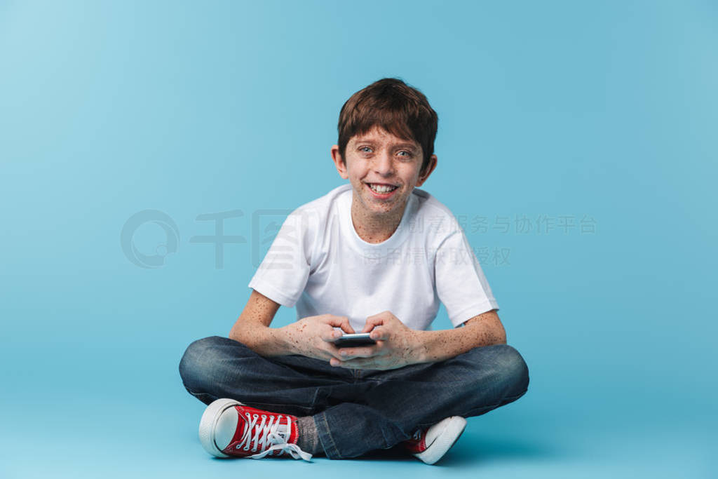 Image of european brunette boy 10-12y with freckles holding and