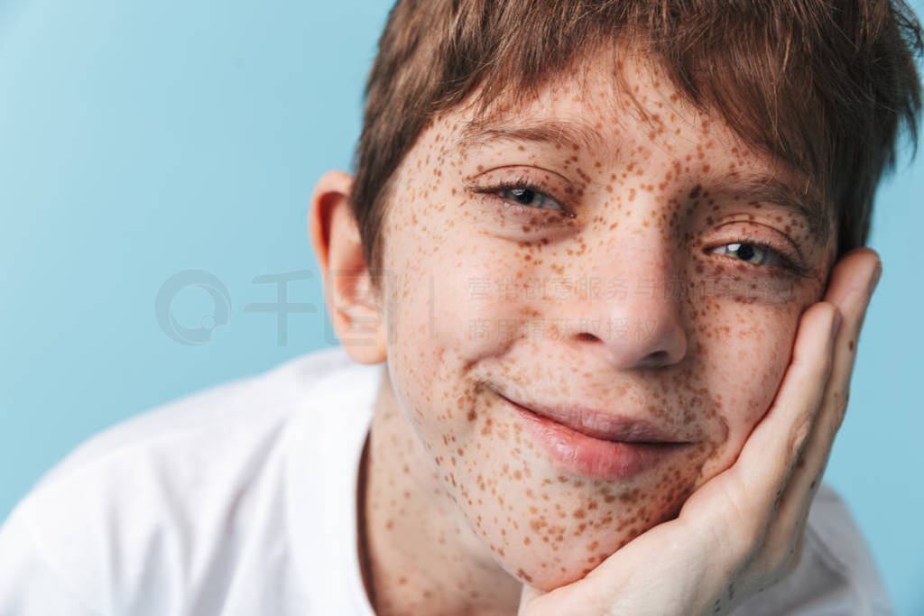 Portrait closeup of carefree beautiful boy 10-12y with freckles