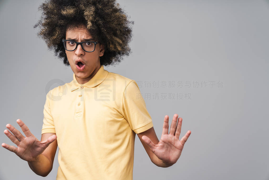 Photo of uptight caucasian man with afro hairstyle showing stop