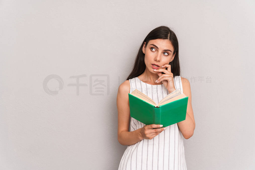 Image of concentrated brunette woman wearing dress thinking and