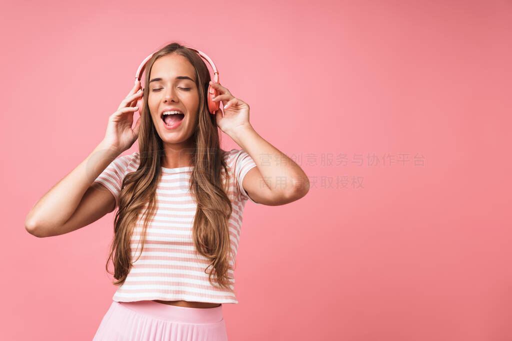 Image of joyful beautiful woman wearing striped clothes singing