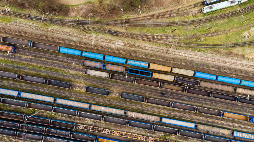 Aerial view of colorful freight trains on the railway station.