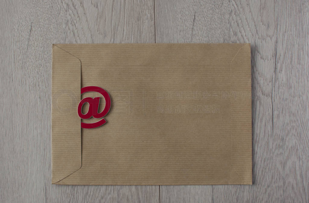 Email simbol at sign on brown envelopes background