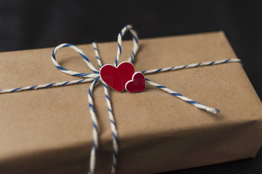 Valentines Day gift box in brown craft paper and red heart.