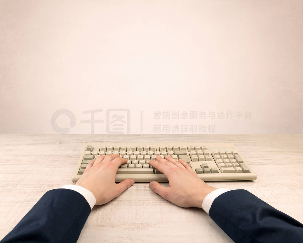 Elegant businessman hand typing on light background