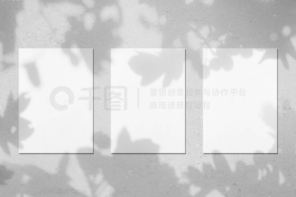 Three empty white vertical rectangle poster mockups with leaves