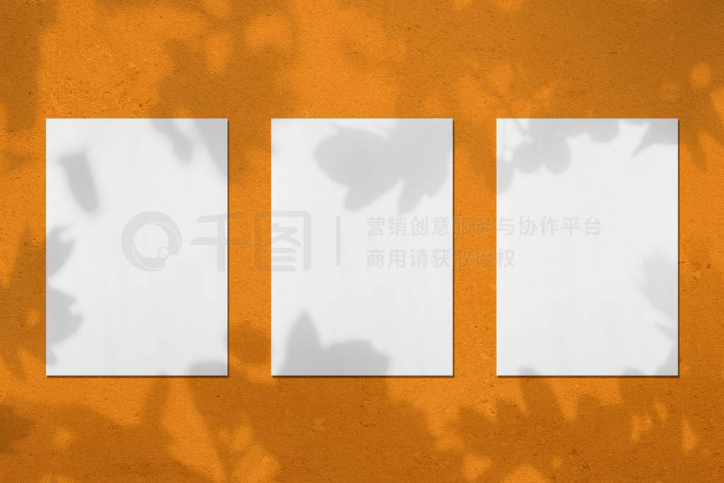 Three empty white vertical rectangle poster mockups with leaves