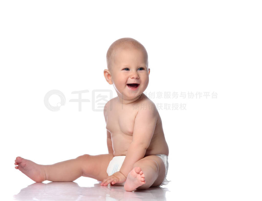 Laughing infant child baby boy toddler in diaper is sitting loo